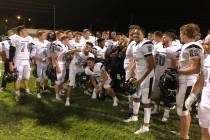 Palo Verde football players pose with the Thursday Night Lights trophy after a 29-6 road vic ...
