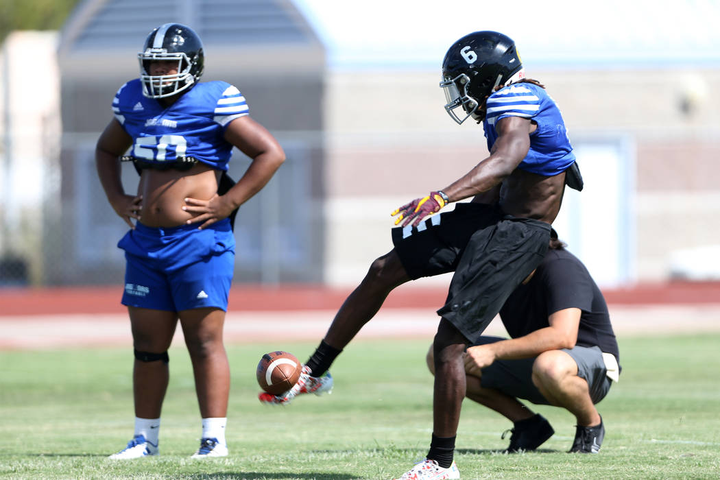 Desert Pines senior running back Cameron Wiley kicks a punt during a team practice at Desert ...