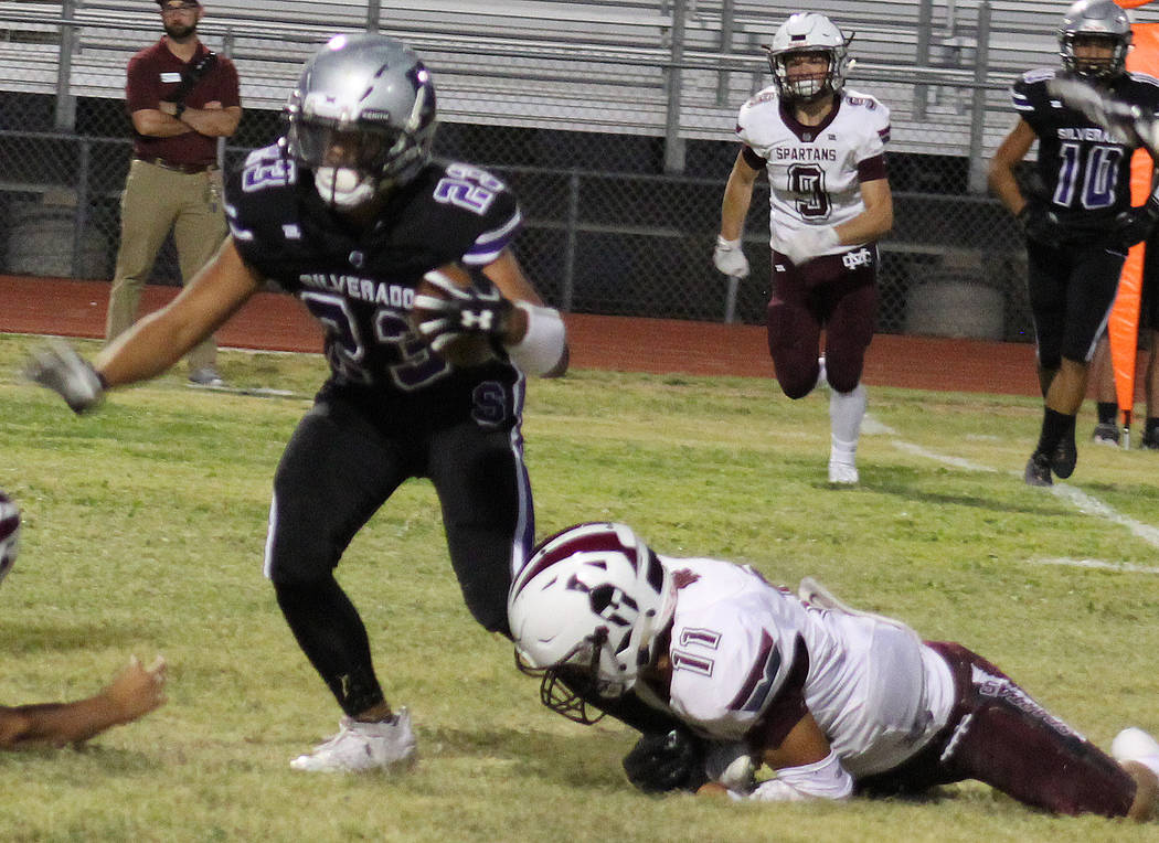 Silverado’s Jordan Norwod (23) is tackled by Cimarron-Memorial’s Jose Carrasco ( ...