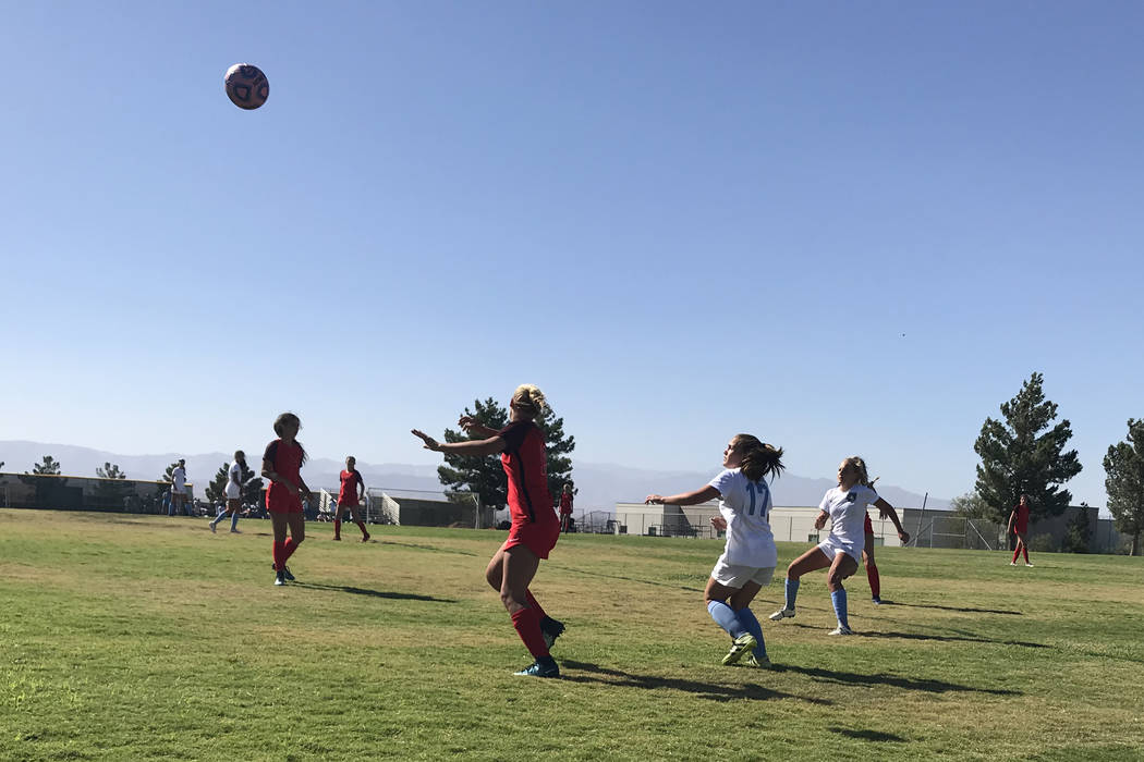 Coronado and Foothill players vie for position to play a ball in the air on Wednesday, Sept. ...