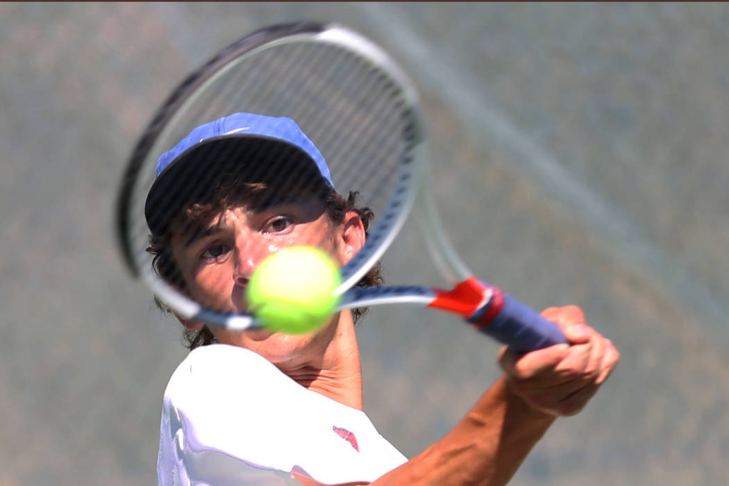 Coronado High singles player Ethan Quandt returns the ball against Clark’s High Rahul ...