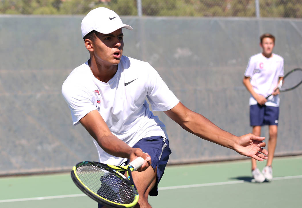 Coronado High double player Scott Hobbs, left, returns the ball against Clark’s High a ...