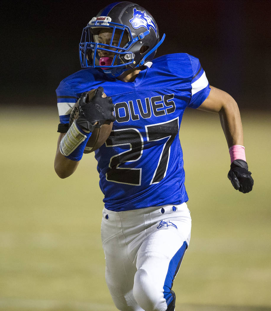 Basic wide receiver Michael Click (27) runs for a touchdown against Foothill defenders durin ...
