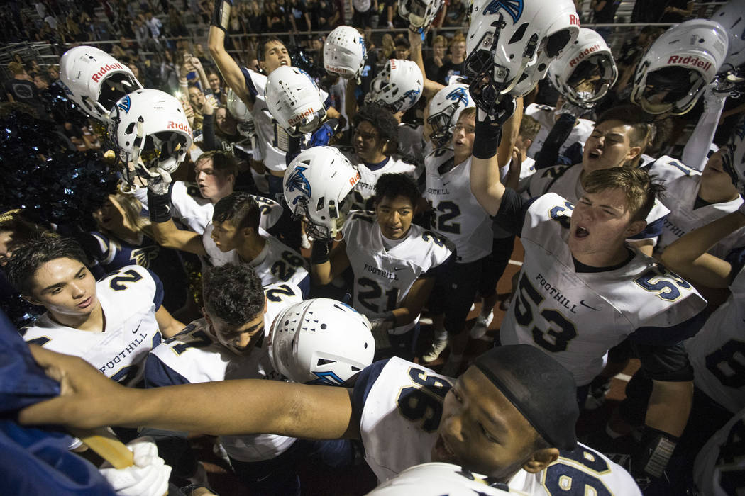 Foothill players celebrate their 21-17 victory over Basic following a varsity football game ...