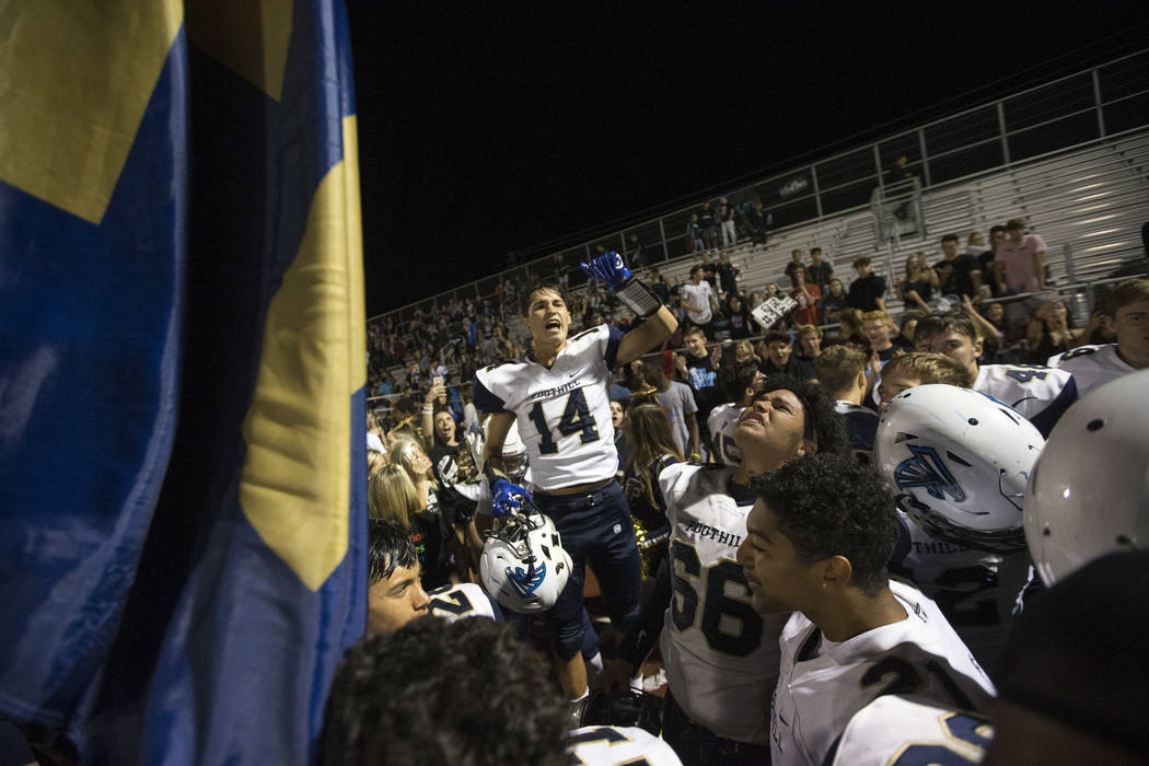 Foothill players, including Devin Cabrales (14), celebrate their 21-17 victory over Basic fo ...