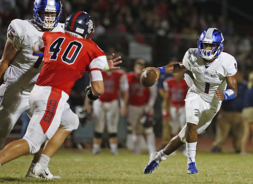 Bishop Gorman’s Micah Bowens (1) scrambles away from Centennial’s Derek Jodarski ...