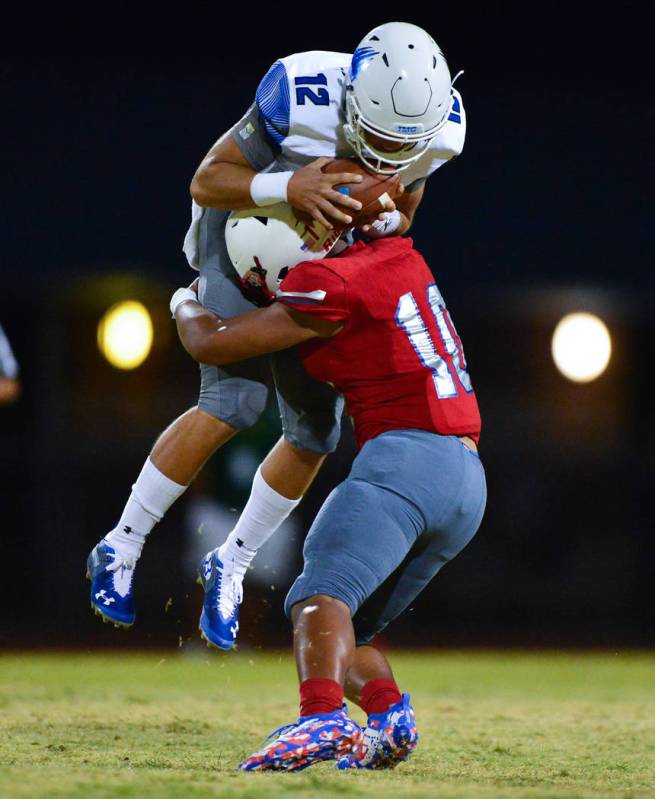 Liberty’s Austin Fiaseu (10) tackles IMG Academy quarterback Bryson Lucero (12) at Lib ...