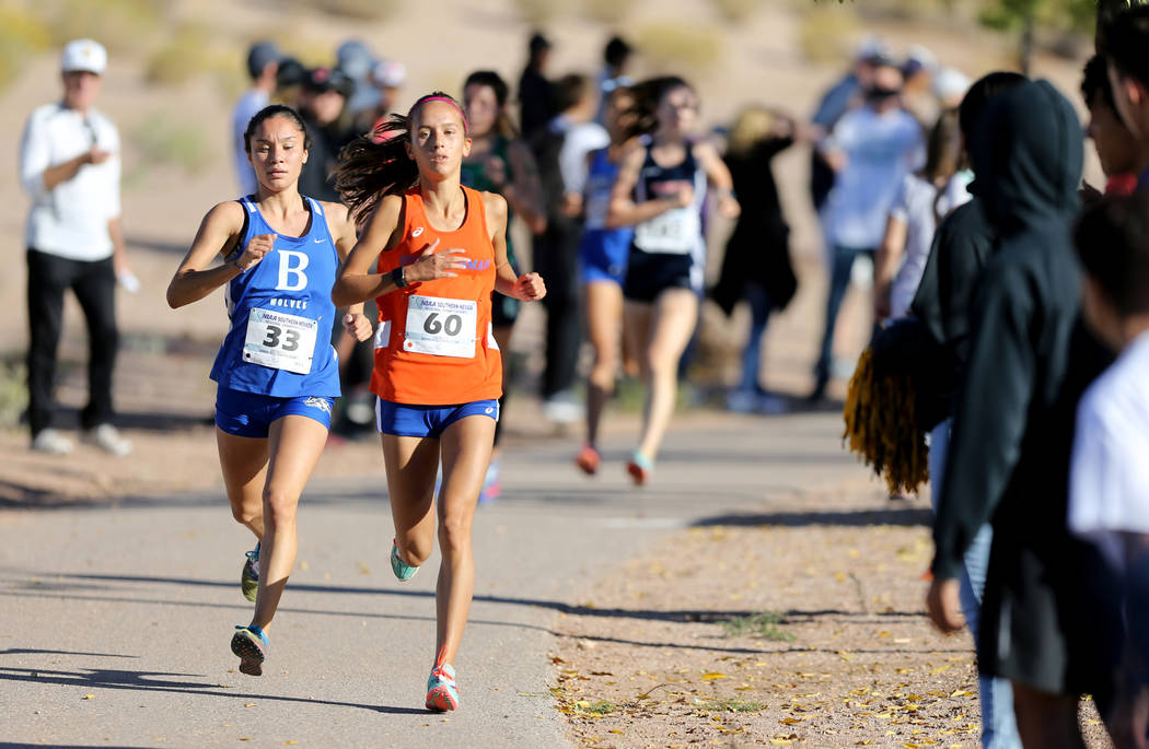 Basic High senior Raquel Chavez, left, closes in on Bishop Gorman sophomore Emilia Puskas du ...