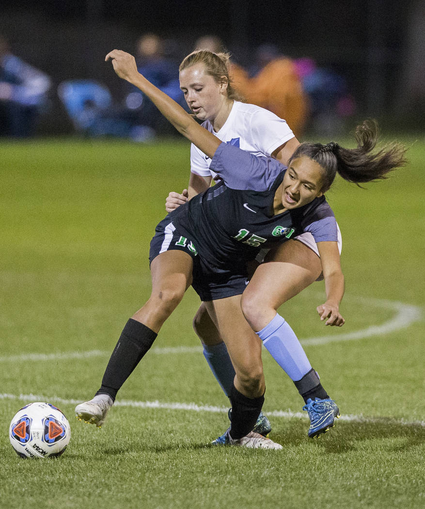 Green Valley junior forward Jazlyn Camacho (15) fights for a loose ball with Foothill senior ...