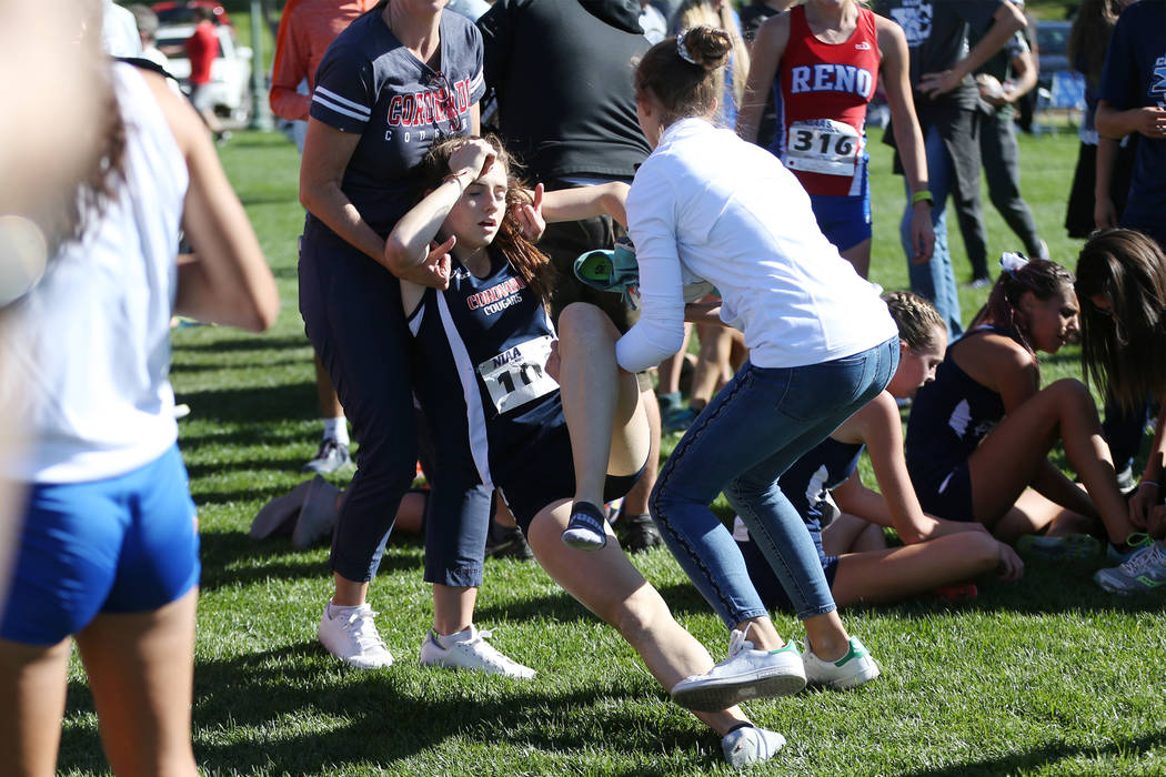 Coronado’s junior Claire Rawlins (101) is carried off the finish line area after finis ...