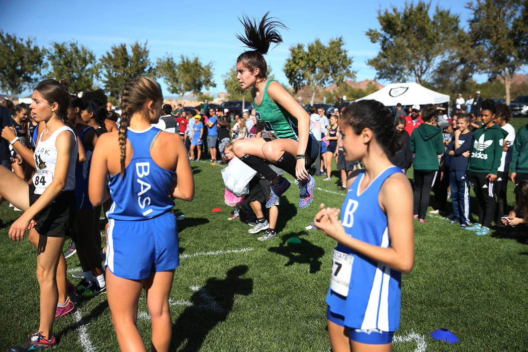 Green Valley’s Mia Smith, 17, center, warms-up to compete in the NIAA 4A Girls Cross C ...