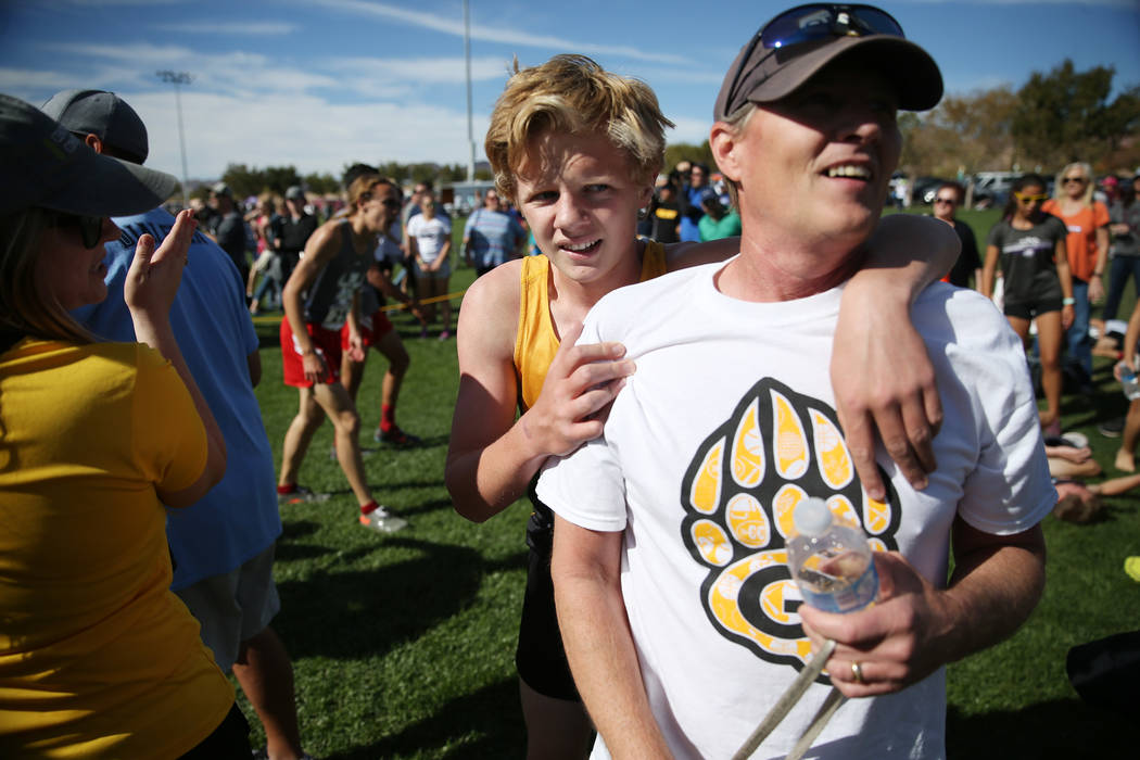 Matthew Gordon, a 16-year-old sophomore from Galena High School in Reno, embraces his father ...
