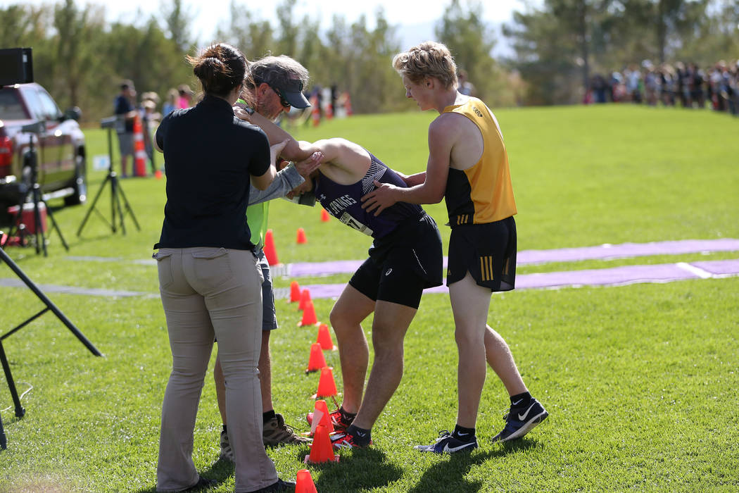 Spanish Springs’ Daniel Horner (377), center, is assisted by first place winner Matthe ...