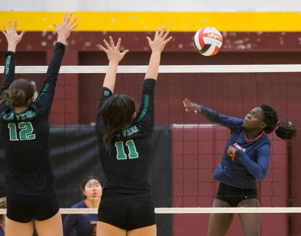 Coronado sophomore Morenike Ajayi (1) spikes the ball over Palo Verde juniors Alyssa Hewitt ...