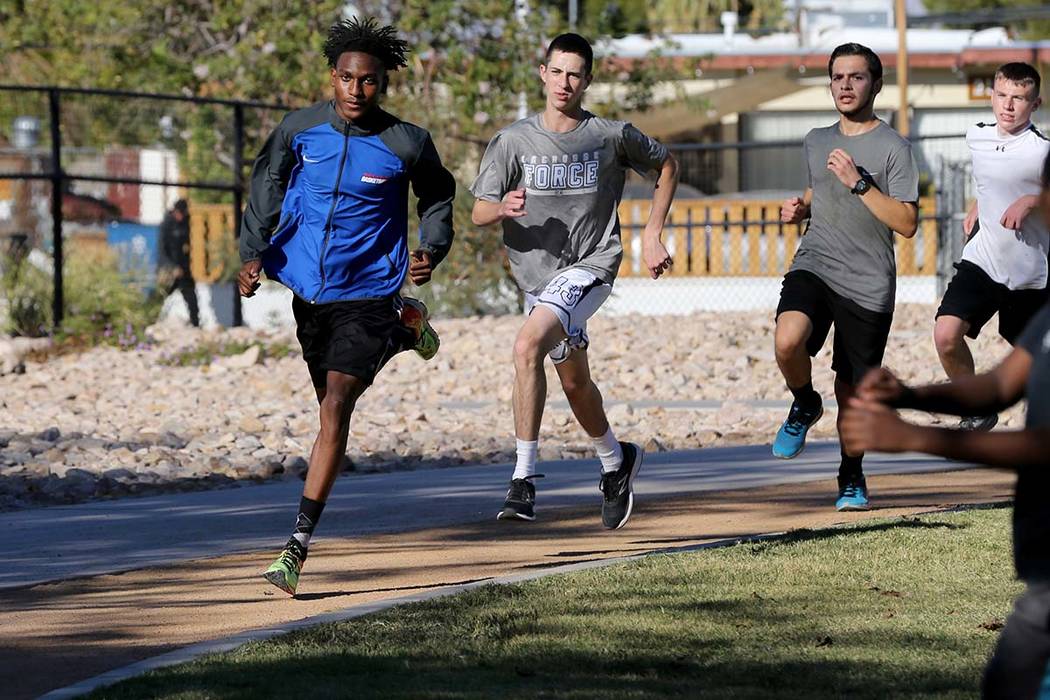 Valley High School cross country runner Christian Franklin, left, practices with his teammat ...