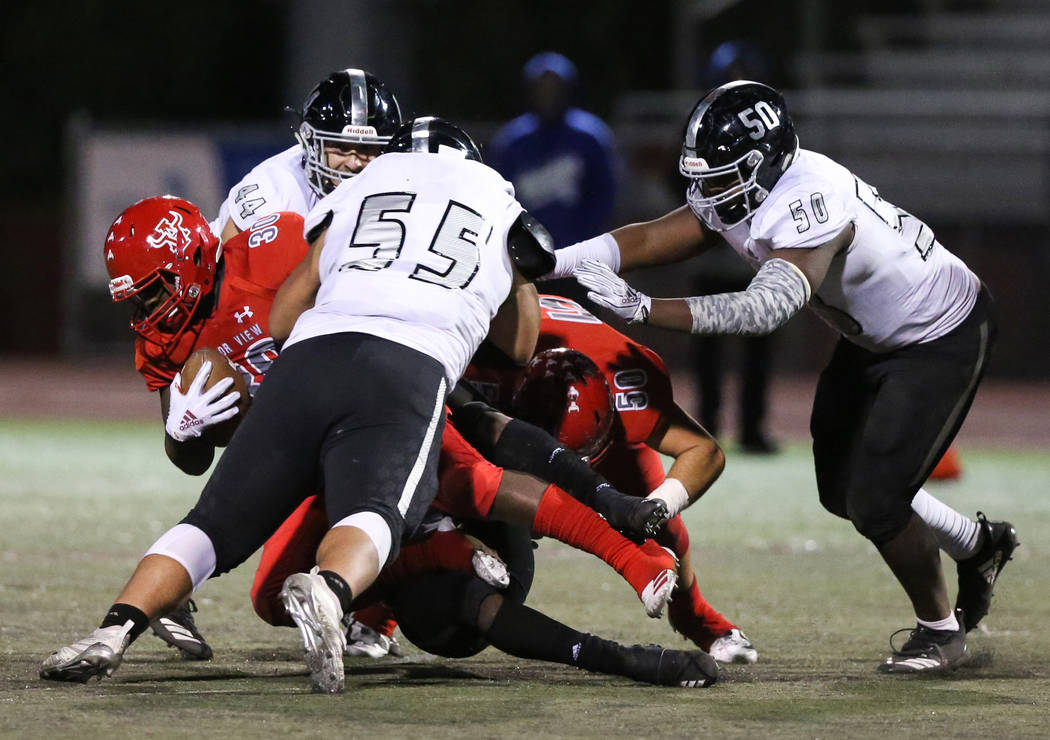 Arbor View’s Darius Williams (30) gets tackled while in possession of the ball during ...