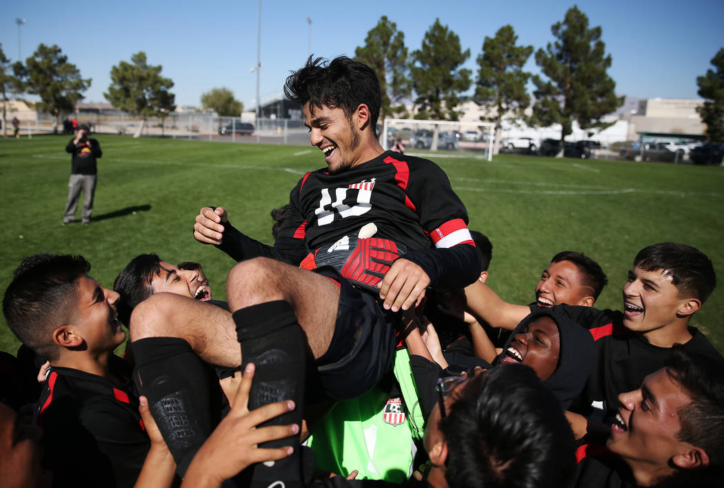 Las Vegas’ Fernando Gomez (10) is lifted up by his team after their win against Corona ...