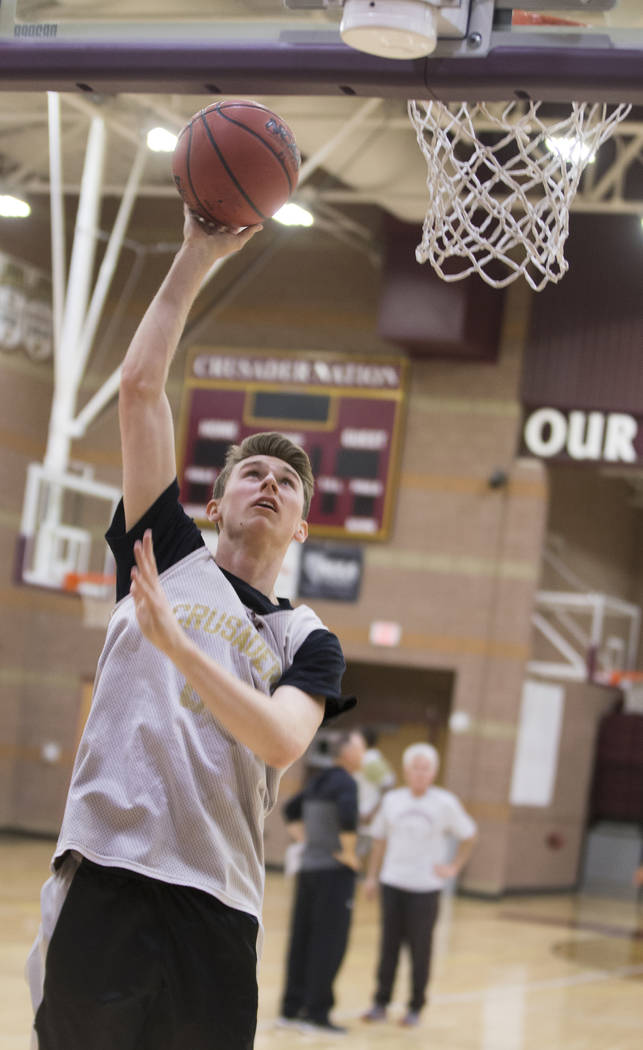 Faith Lutheran senior guard Brevin Walter runs through a layup drill during practice on Mond ...