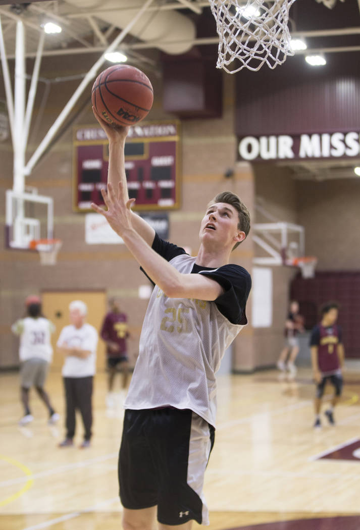 Faith Lutheran senior guard Brevin Walter runs through a layup drill during practice on Mond ...