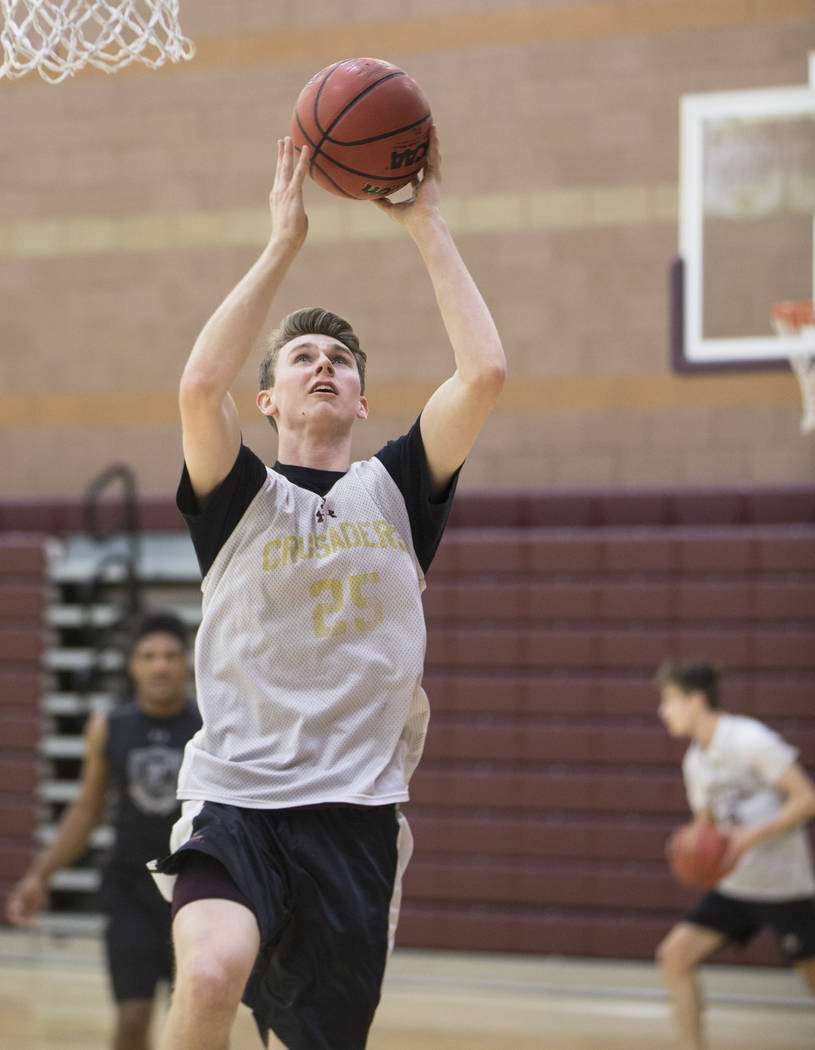 Faith Lutheran senior guard Brevin Walter runs through a layup drill during practice on Mond ...