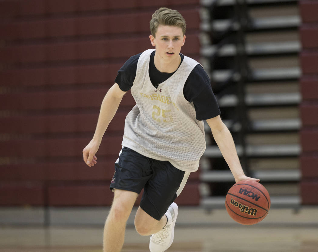 Faith Lutheran senior guard Brevin Walter runs through a dribbling drill during practice on ...