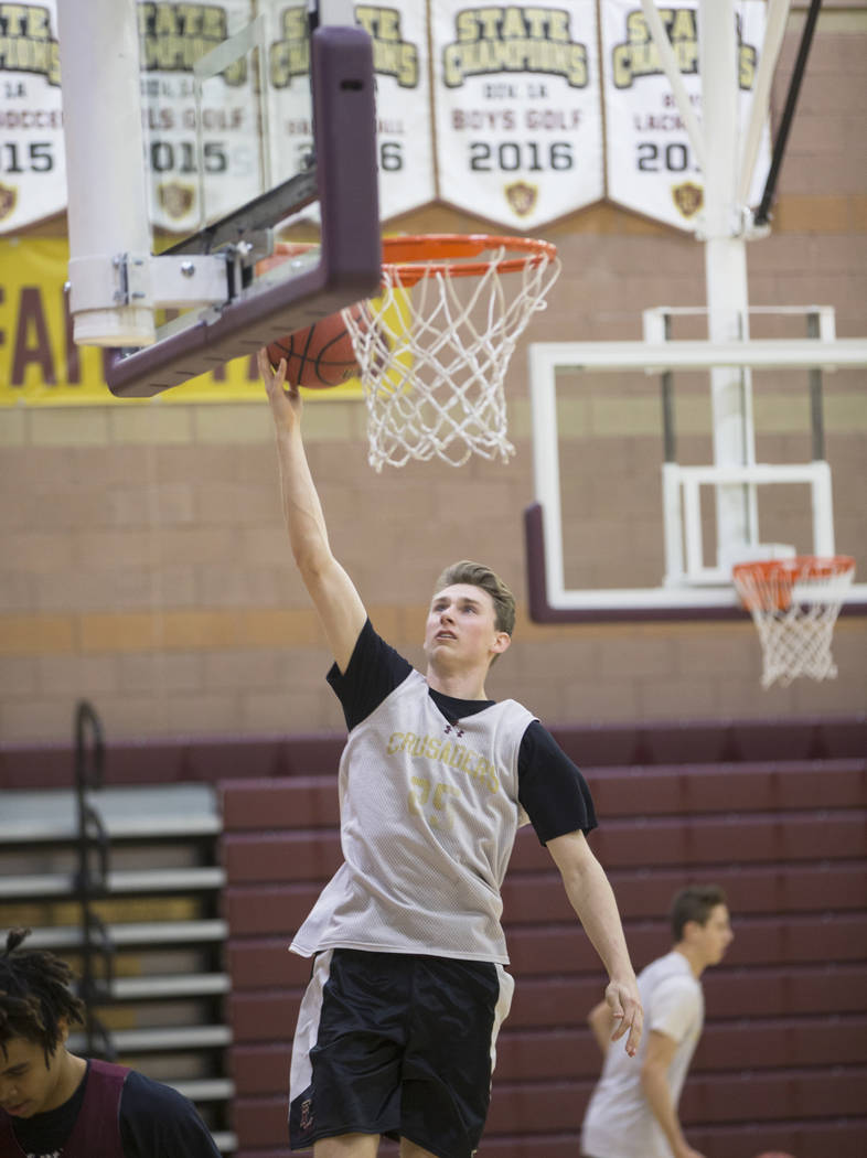 Faith Lutheran senior guard Brevin Walter runs through a layup drill during practice on Mond ...