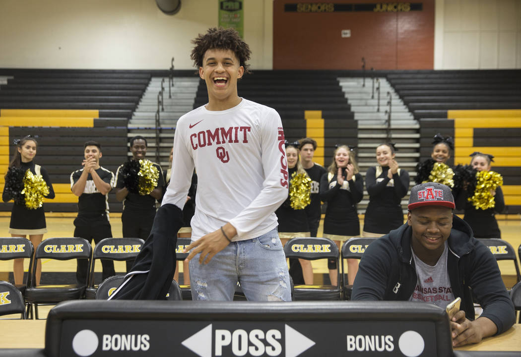 Clark senior Jalen Hill, left, shows off his Sooner colors during an event to announce his c ...