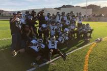 Spring Mountain football players pose with the Class 1A state championship trophy after a 60 ...