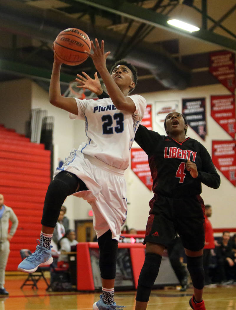 Canyon Springs’ Kayla Johnson (23) looks to shoot while Liberty’s Robin Walker ( ...
