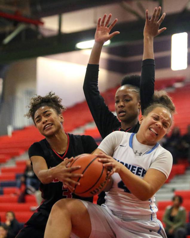 Liberty’s Journie Augmon (3) and Olivia Children (23) fight for the ball against Canyo ...