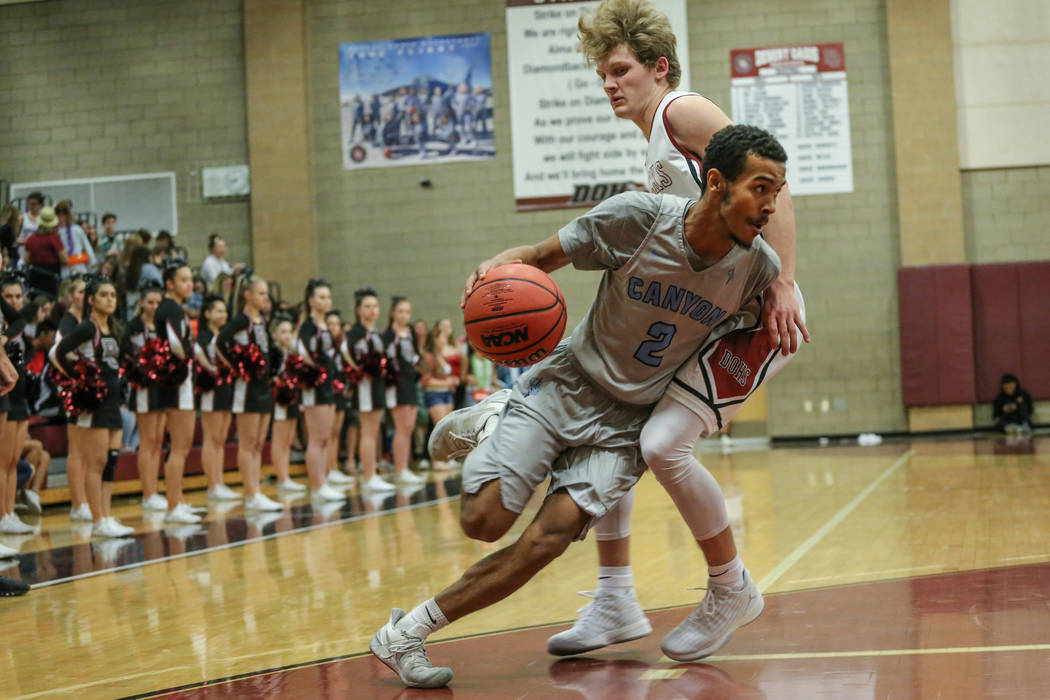 Canyon Springs’ Alexander Spaight (2), left, dribbles the ball as he is guarded by Des ...
