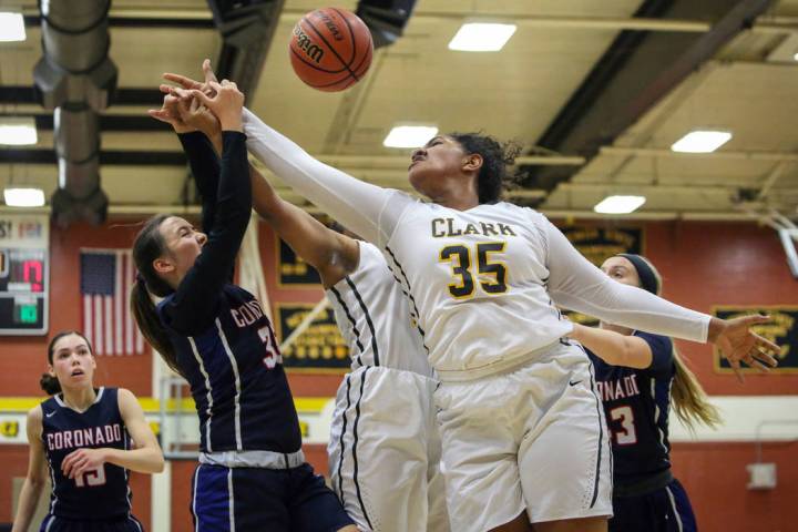 Coronado’s Alexee Johnson (35) and Clark’s Coraly Dupree (35) reach to grab the ...