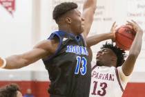 Cimarron-Memorial senior Brian Lang (13) collides with Desert Pines junior Darnell Washingt ...