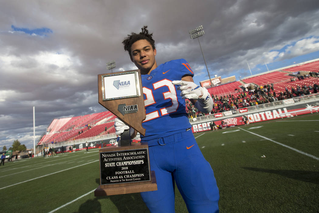 Bishop Gorman running back Amod Cianelli (23) celebrates with the trophy after Gorman defeat ...