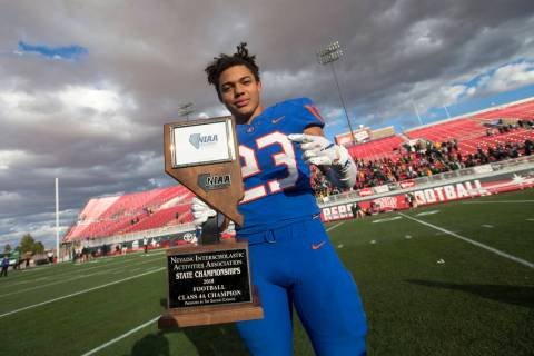Bishop Gorman running back Amod Cianelli (23) celebrates with the trophy after Gorman defeat ...