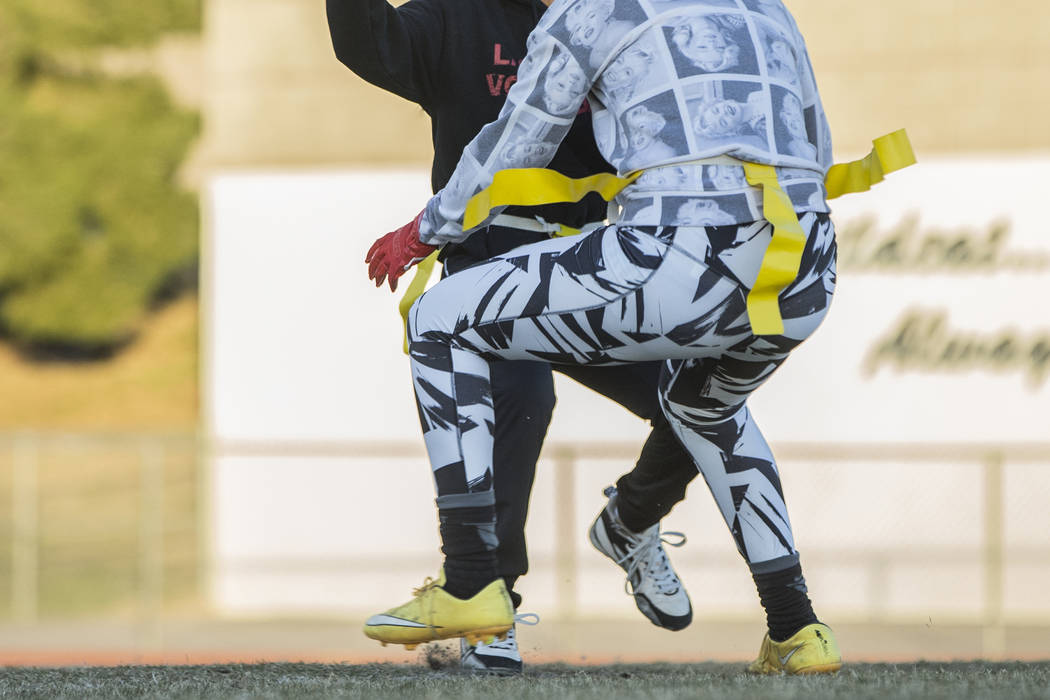 Las Vegas quarterback Sabrina Saldate dishes the ball before being tackled during flag footb ...