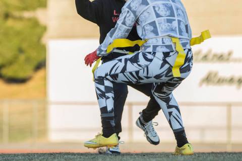 Las Vegas quarterback Sabrina Saldate dishes the ball before being tackled during flag footb ...