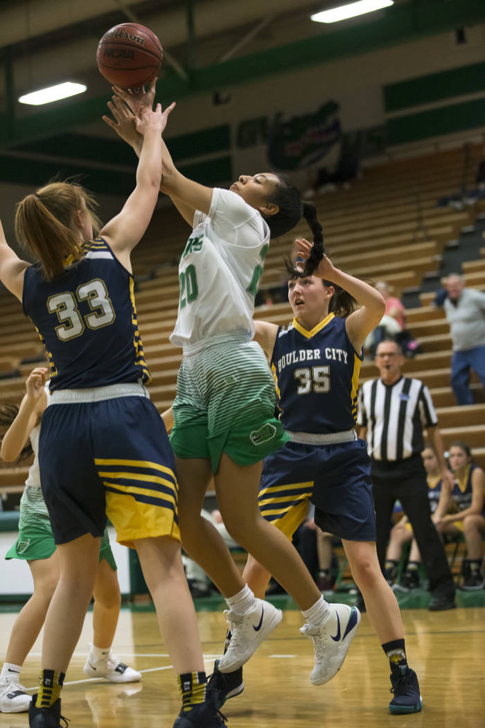 Green Valley’s Michelle Lagunas-Monroy (20) and Boulder City center Ellie Howard (33) ...