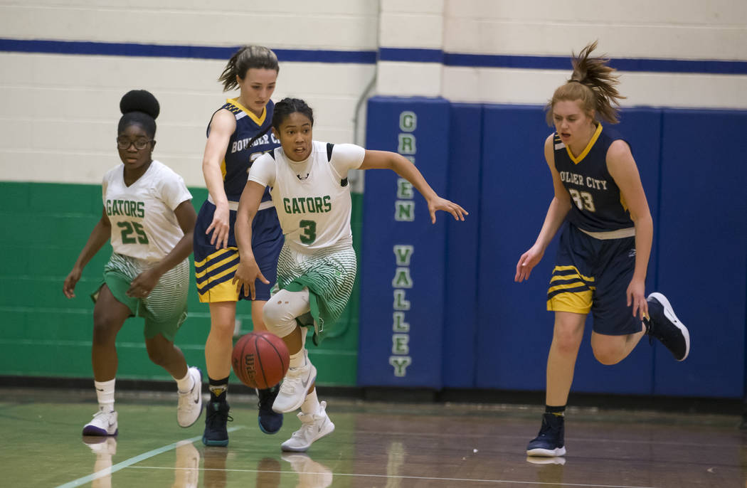 Green Valley’s Amore Espino (3) breaks away from Boulder City defenders during the fir ...