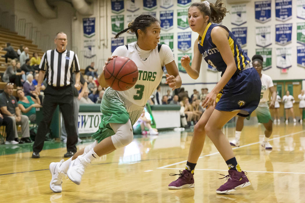 Green Valley’s Amore Espino (3) drives the ball past Boulder City forward Setia Cox (3 ...