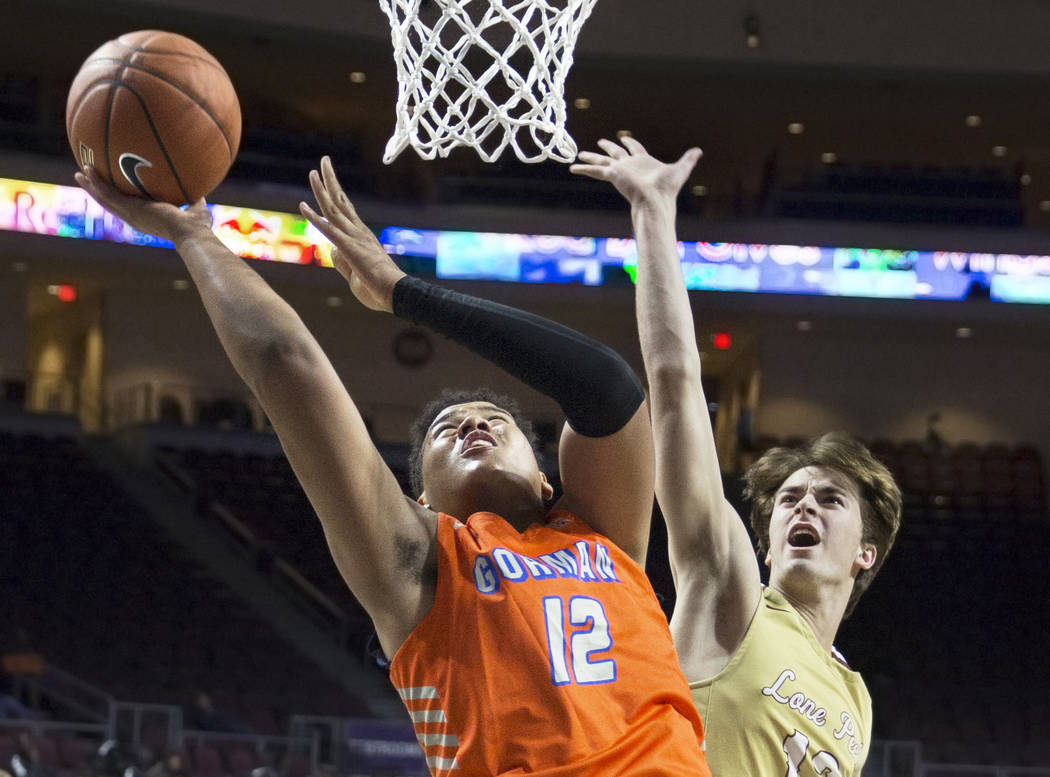 Bishop Gorman freshman forward Max Allen (12) drives past Lone Peak junior guard Jared Jense ...