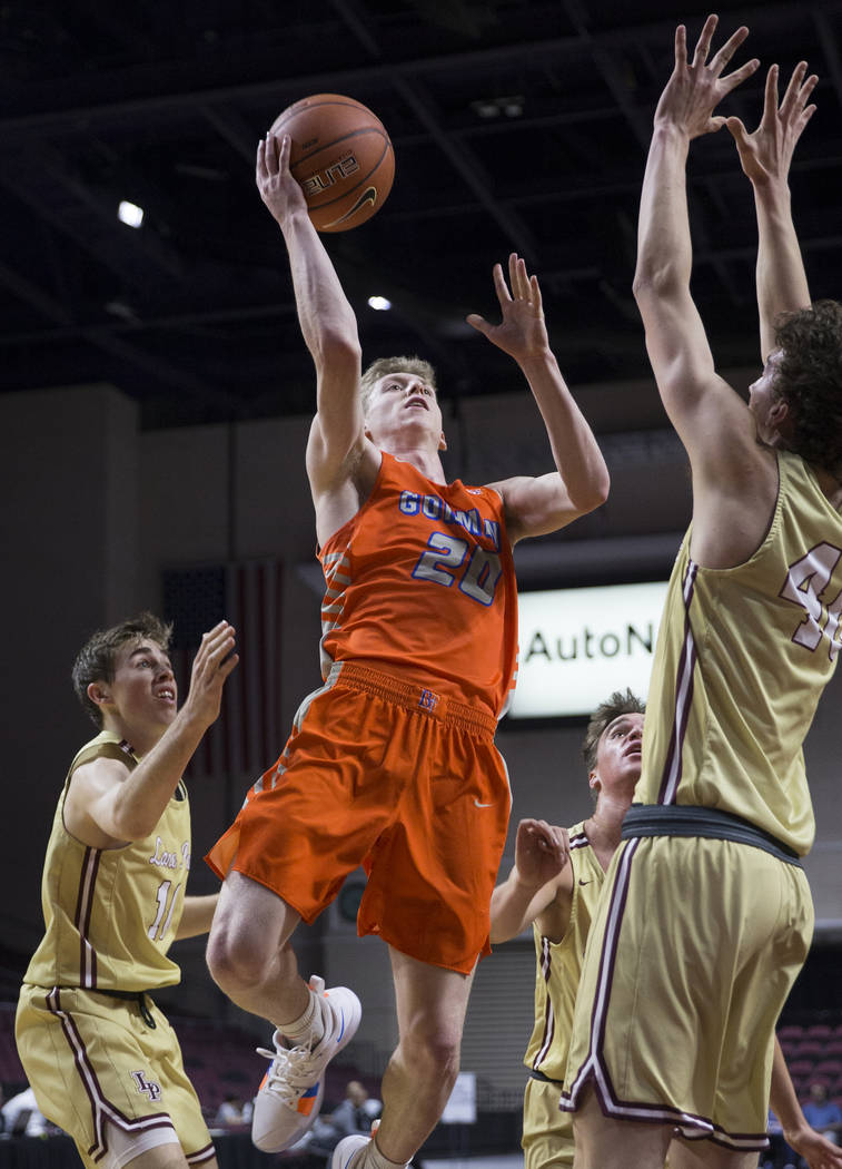 Bishop Gorman senior guard Noah Taitz (20) drives past Lone Peak sophomore center Cameron Br ...