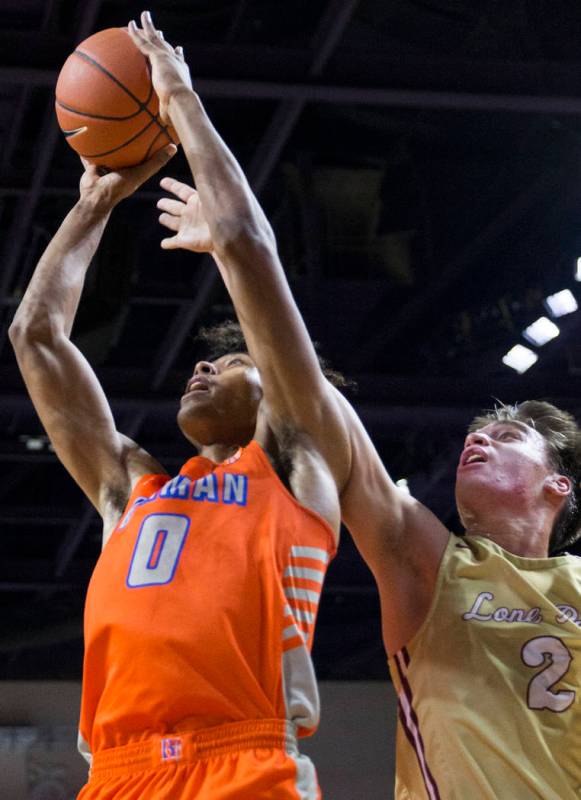 Bishop Gorman junior forward Isaiah Cottrell (0) drives past Lone Peak junior guard Hunter H ...