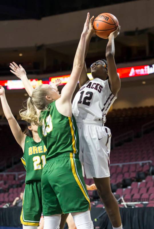 Desert Oasis’ Jordyn Stroud (12) takes a shot over Brea Olinda’s Casey Fust (13) ...