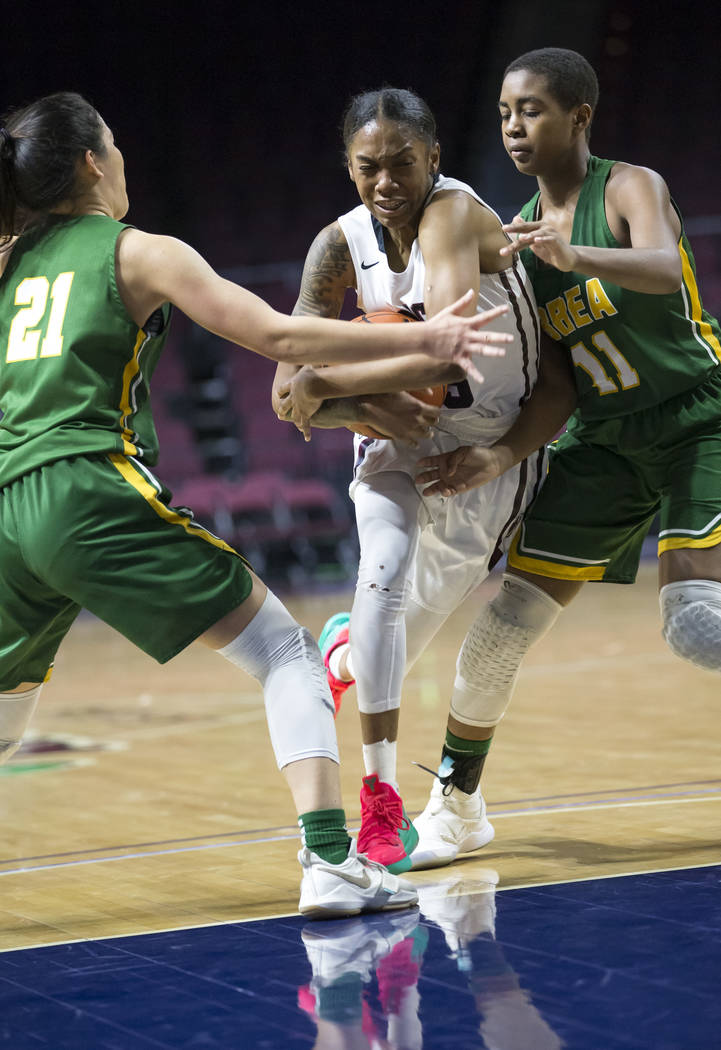 Desert Oasis’ Ahmaya Smith (15) carries the ball through Brea Olinda defenders Rilee P ...