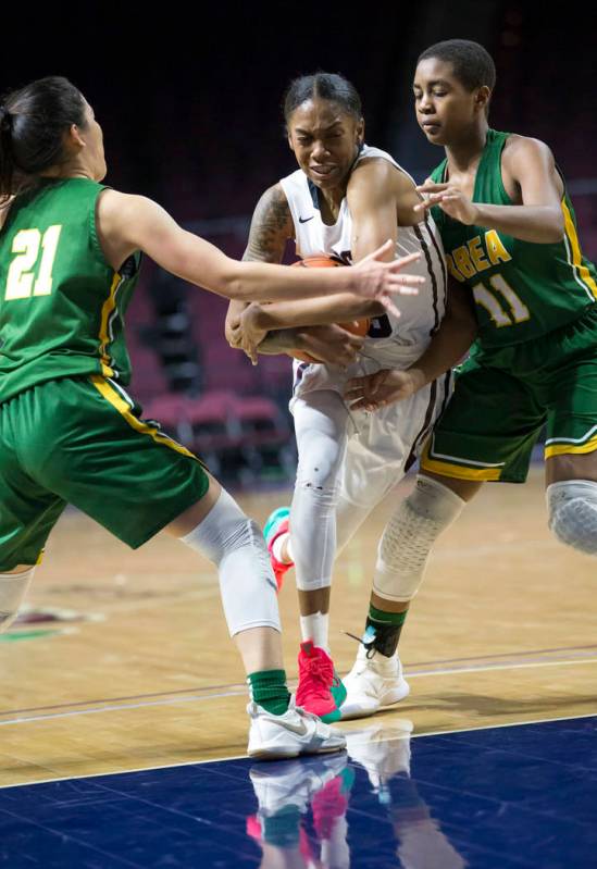 Desert Oasis’ Ahmaya Smith (15) carries the ball through Brea Olinda defenders Rilee P ...