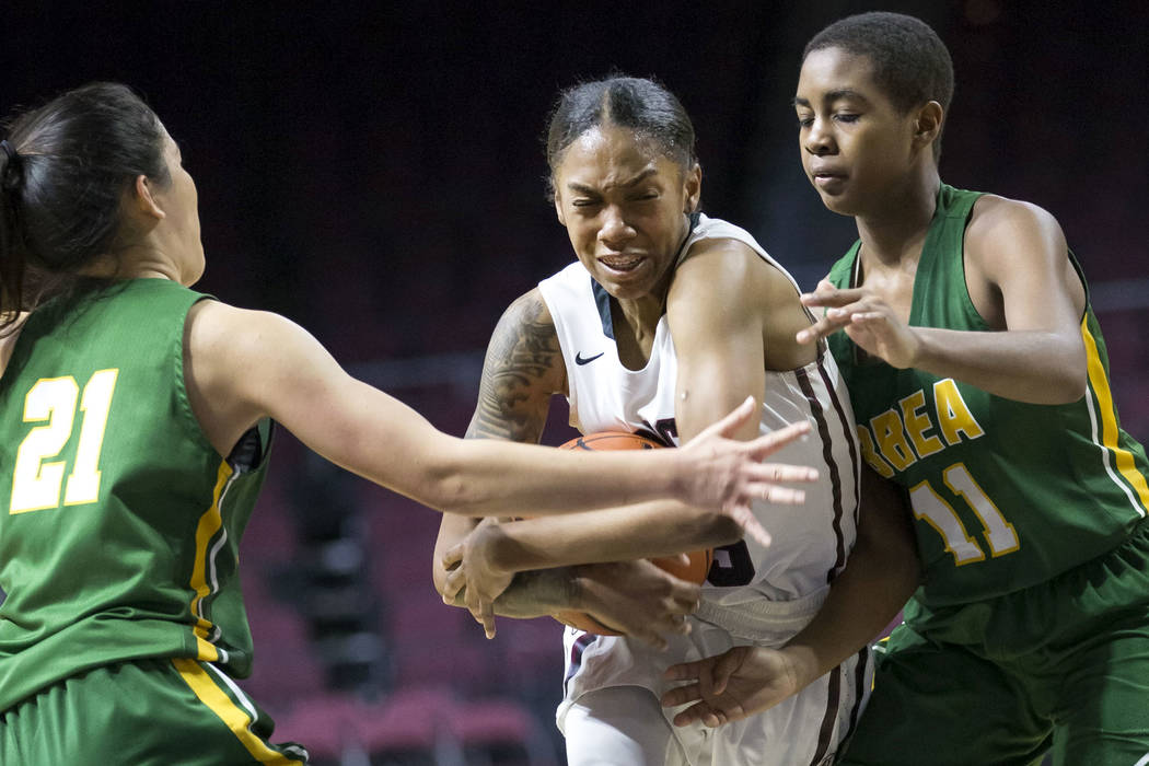 Desert Oasis’ Ahmaya Smith (15) carries the ball through Brea Olinda defenders Rilee P ...