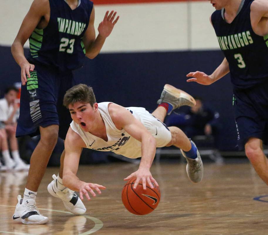 Foothill’s Fisher Welch (12) falls to the ground with the ball while under pressure fr ...