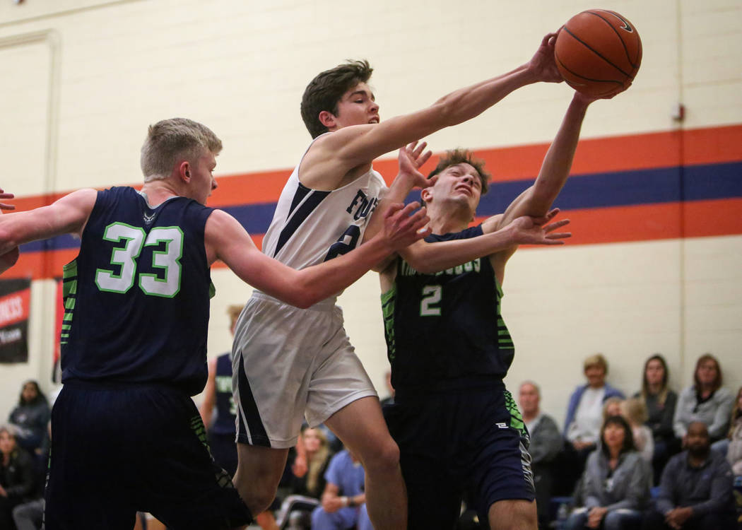 Foothill’s Rudger Welch (24) reaches for the ball while under pressure from Timpanogos ...