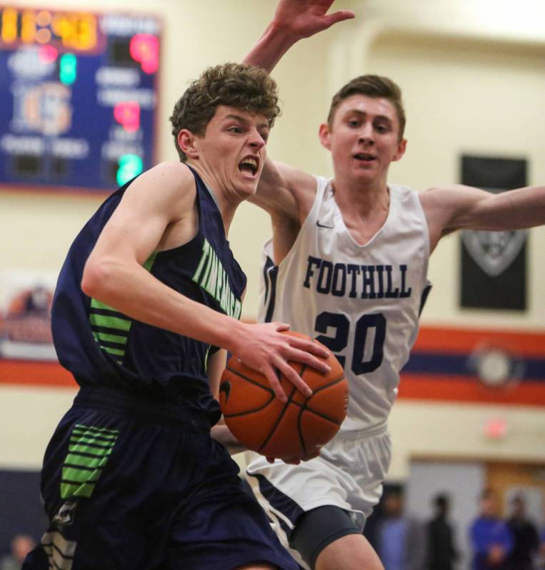 Timpanogos’ Trey Anderson (5) runs with the ball as Foothill’s Caleb Stearman (2 ...